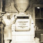 A production manager shows off the company's mixer, circa 1932.