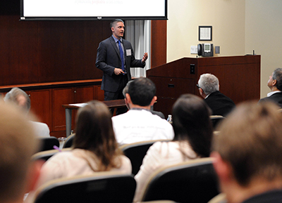 John Lewandowski presents DDG's business model to judges. The company produces a device that can accurately diagnose malaria for one-tenth the cost of current techniques.